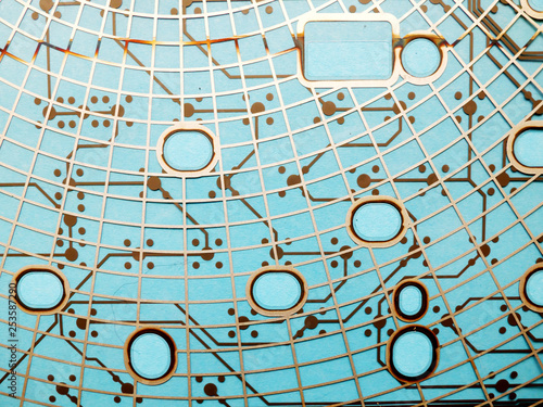 Circuit board made of plastic with circuit traces on blue background. The concept of technology, computing, electronics.