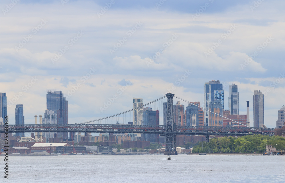 Manhattan bridge and skyline of New York City with skyscrapers background. View from Roosevelt Island