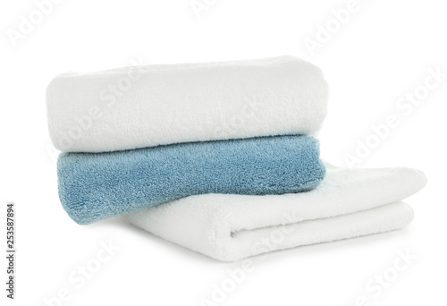 Folded clean soft towels on white background