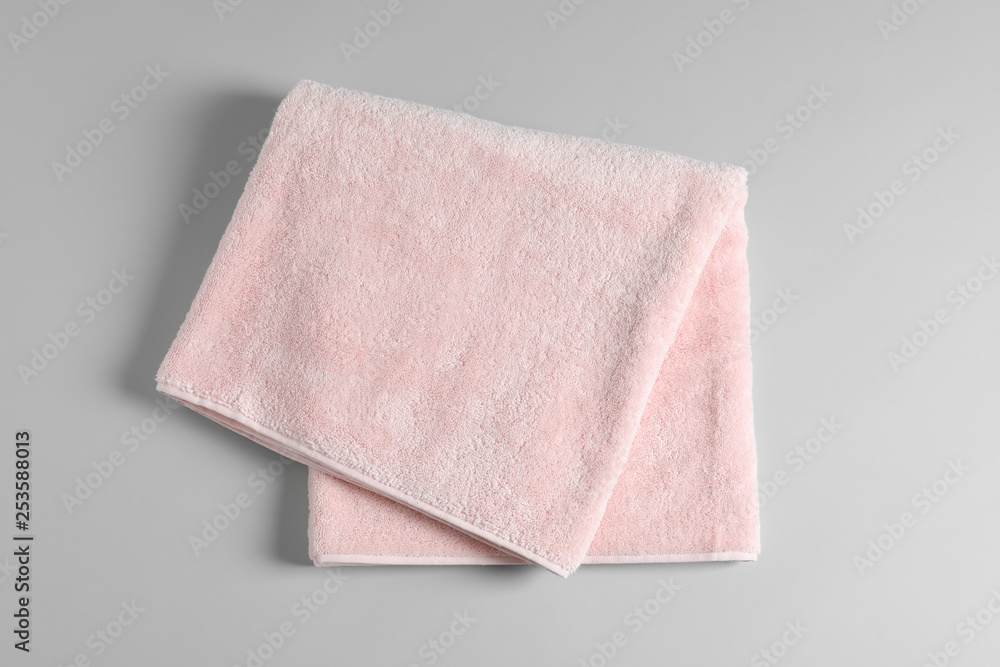 Soft folded towel on light background, top view Soft folded towel on light background, top view