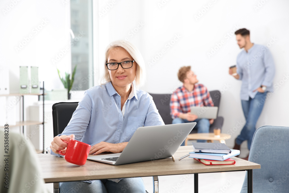 Obraz premium Businesswoman with colleagues working in office, space for text. Professional communication