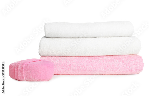Folded soft terry towels and sponge on white background