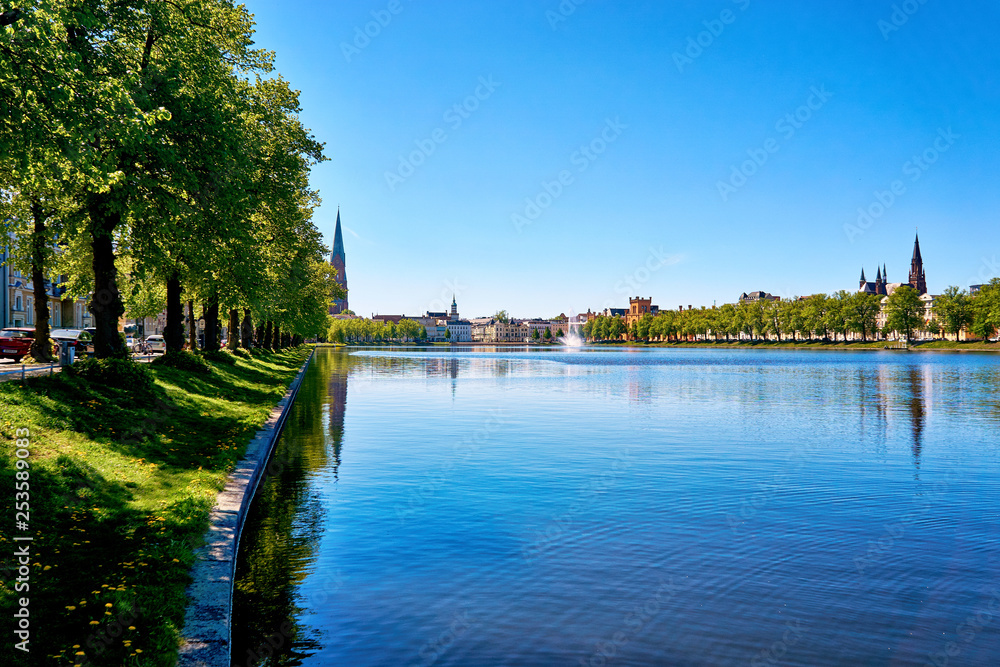 Promenade at the Pfaffenteich with view of the Schwerin old town. Mecklenburg-Western Pomerania, Germany