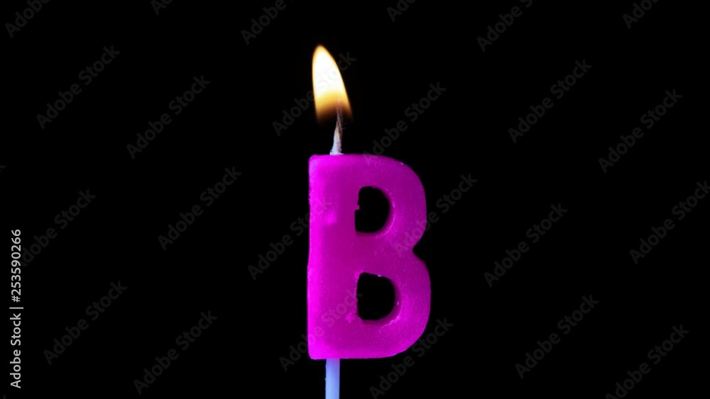 Letter B celebration birthday candle against a black background Letter B celebration birthday candle against a black background