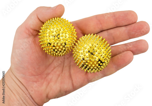 Massage balls in hand isolated on white