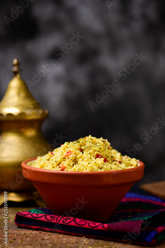 earthenware bowl with tabbouleh on a set table photo