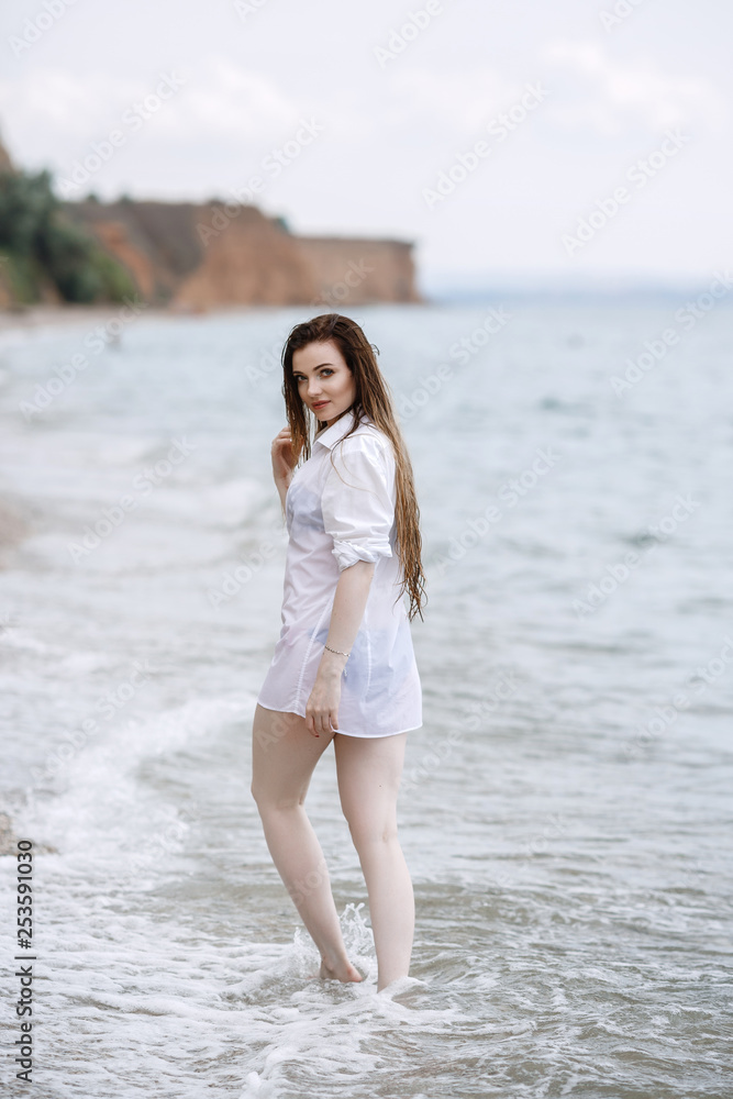 woman in white clothing refreshing at the seaside woman in white clothing refreshing at the seaside