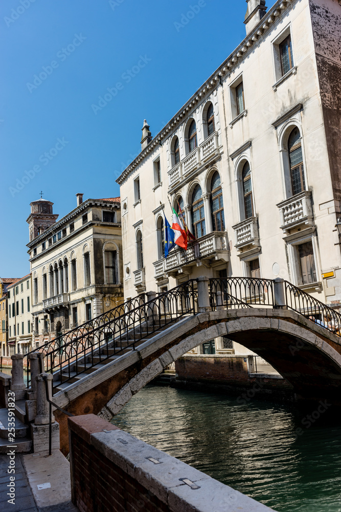 Italy, Venice, a bridge over water with a city in the background