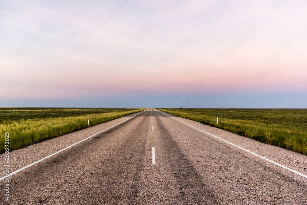 straight road through the outback of Australia, after a beautiful sunset, Nothern territory