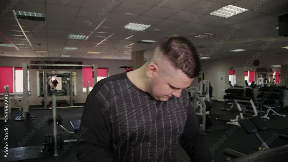 Fat man exercising on the treadmill in the gym. Fat man exercising on the treadmill in the gym.