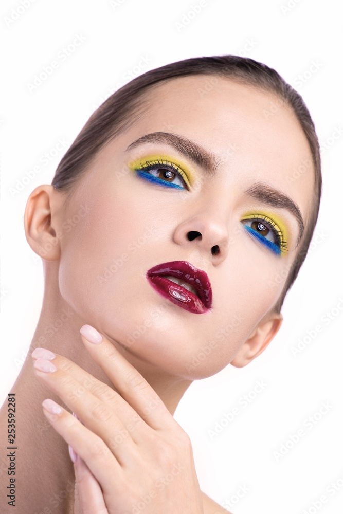 beauty portrait of a young girl on an isolated background. the girl raised her hand to her face. delicate portrait and bright make-up beauty portrait of a young girl on an isolated background. the girl raised her hand to her face. delicate portrait and bright make-up