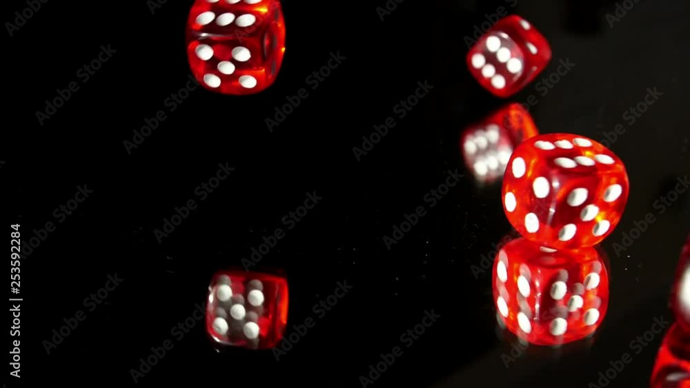 Rolling Red Casino Dice on Glass Table in the Dark Slow Motion Rolling Red Casino Dice on Glass Table in the Dark Slow Motion