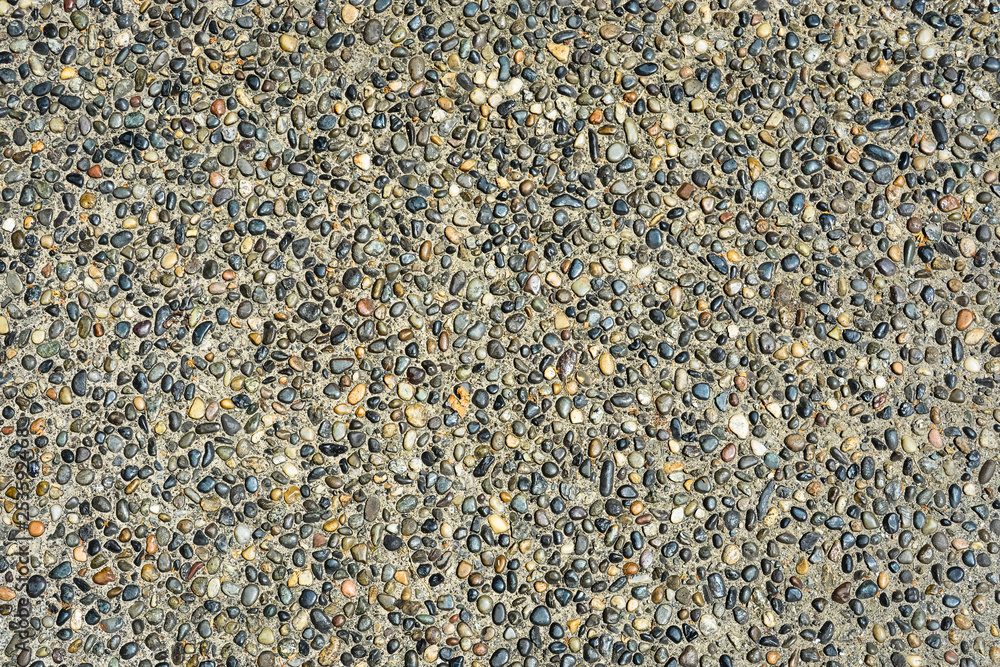 Small colored stones in concrete texture background Small colored stones in concrete texture background