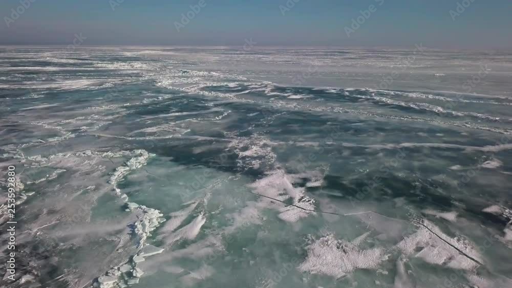 Flying over lighthouse to reveal the ice and shoreline on frozen lake Erie in January. Flying over lighthouse to reveal the ice and shoreline on frozen lake Erie in January.