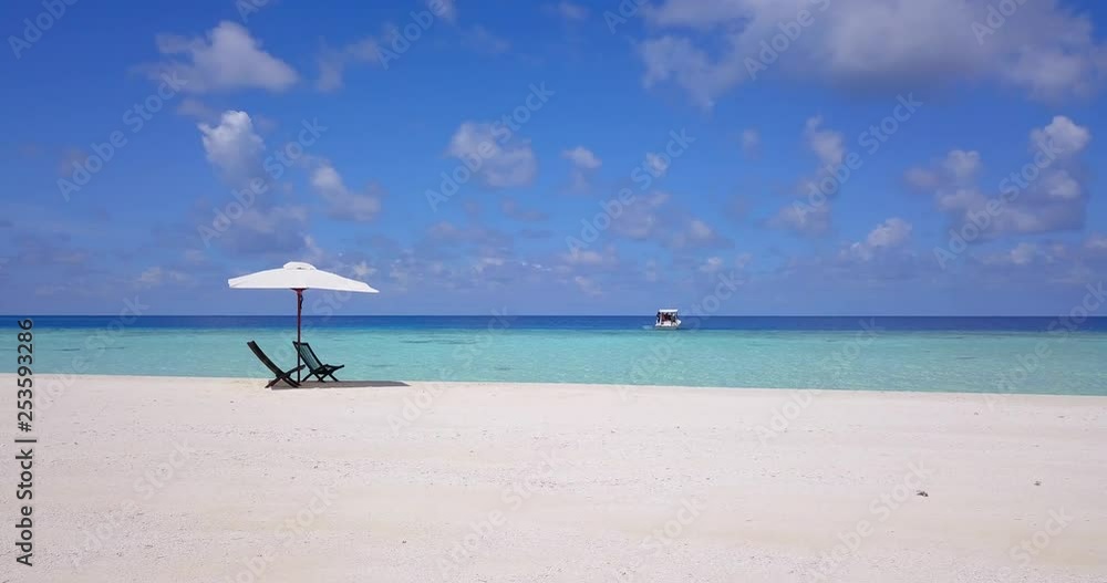 a slow slider move on the white beaches of the turquoise Caribbean sea, with two empty wooden seats under a white parasol a slow slider move on the white beaches of the turquoise Caribbean sea, with two empty wooden seats under a white parasol