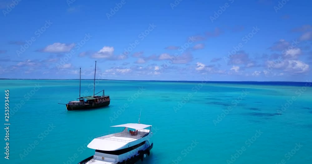 touristic boats anchored at the turquoise waters of a tropical island, drone footage touristic boats anchored at the turquoise waters of a tropical island, drone footage