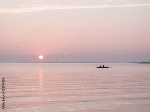 Rowboat and sunset on the sea