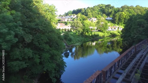 Arial view of railway bridge, woman walking across. photo