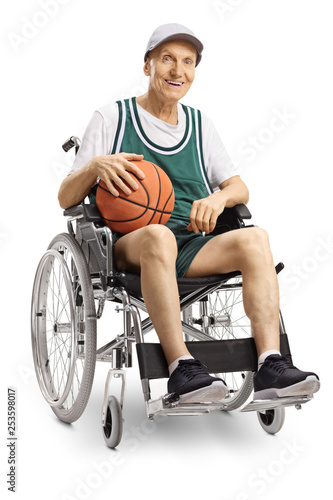Senior disabled man holding a basketball and sitting in a wheelchair © Ljupco Smokovski
