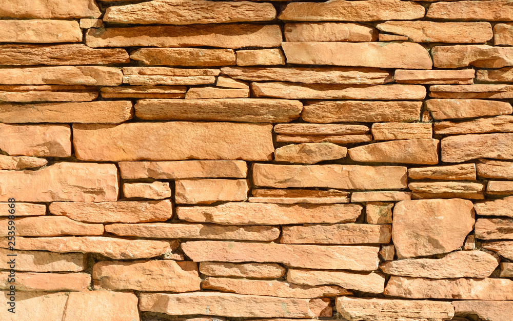 Sand colored stone setting. Stone wall texture