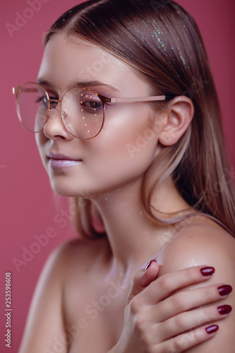 glamor woman in glasses on a pink background