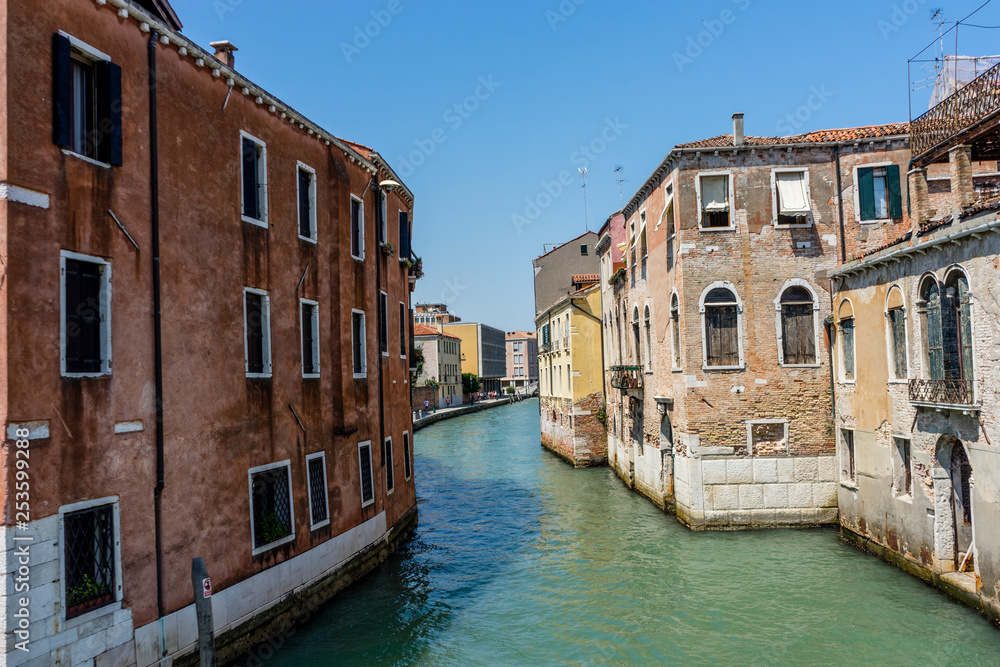 Italy, Venice, Hotel Pantalon, CANAL AMIDST BUILDINGS AGAINST CLEAR SKY