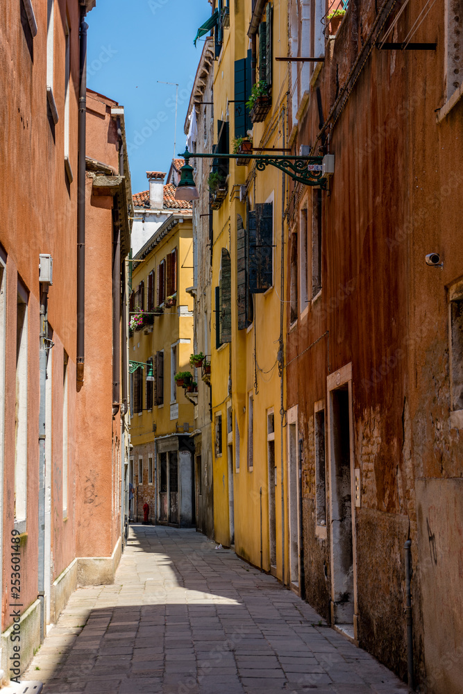 Italy, Venice, a narrow street in front of a brick building