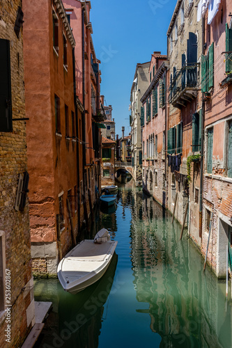 Italy, Venice, Grand Canal, BOATS MOORED ON CANAL AMIDST BUILDINGS IN CITY AGAINST SKY