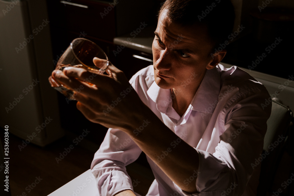 Fototapeta premium Guy with brandy in the kitchen