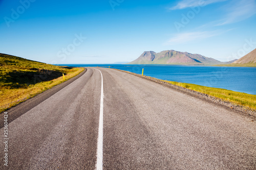 Empty road leading along the coast. Typical Icelandic landscape.