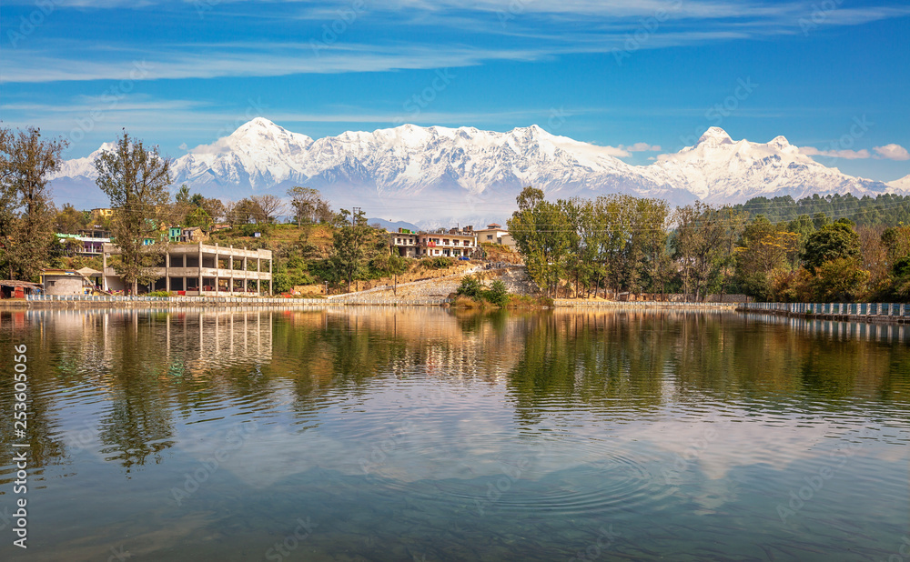 Scenic landscape view of a small village town with adjoining lake at Bageshwar district Uttarakhand with full panoramic view of the Garhwal Himalaya range.