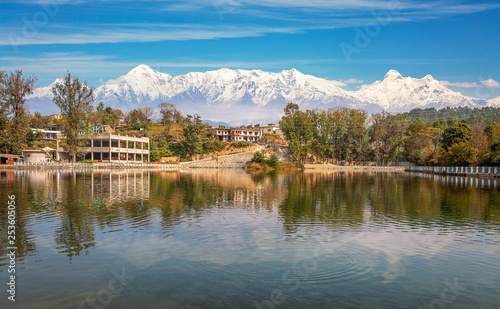 Scenic landscape view of a small village town with adjoining lake at Bageshwar district Uttarakhand with full panoramic view of the Garhwal Himalaya range.