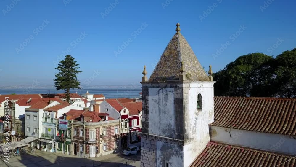 Aerial view of the tower of the church of Alcochete, Portugal with background of Tagus river Aerial view of the tower of the church of Alcochete, Portugal with background of Tagus river