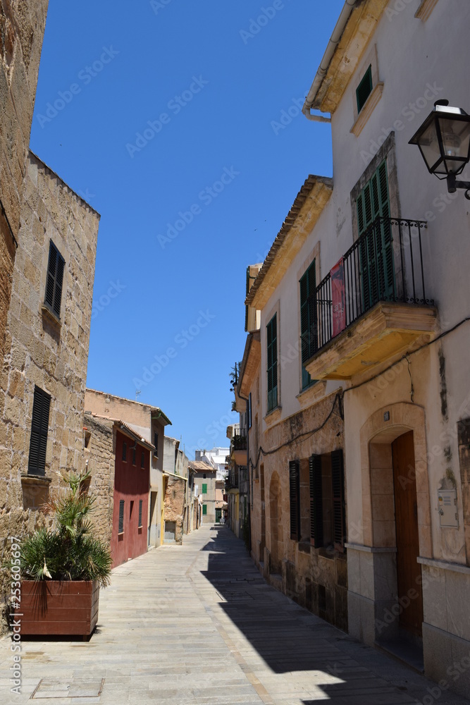 Little old stony alley in europe on a spanish island, with an blue sky, perfect to walk through and take pictures
