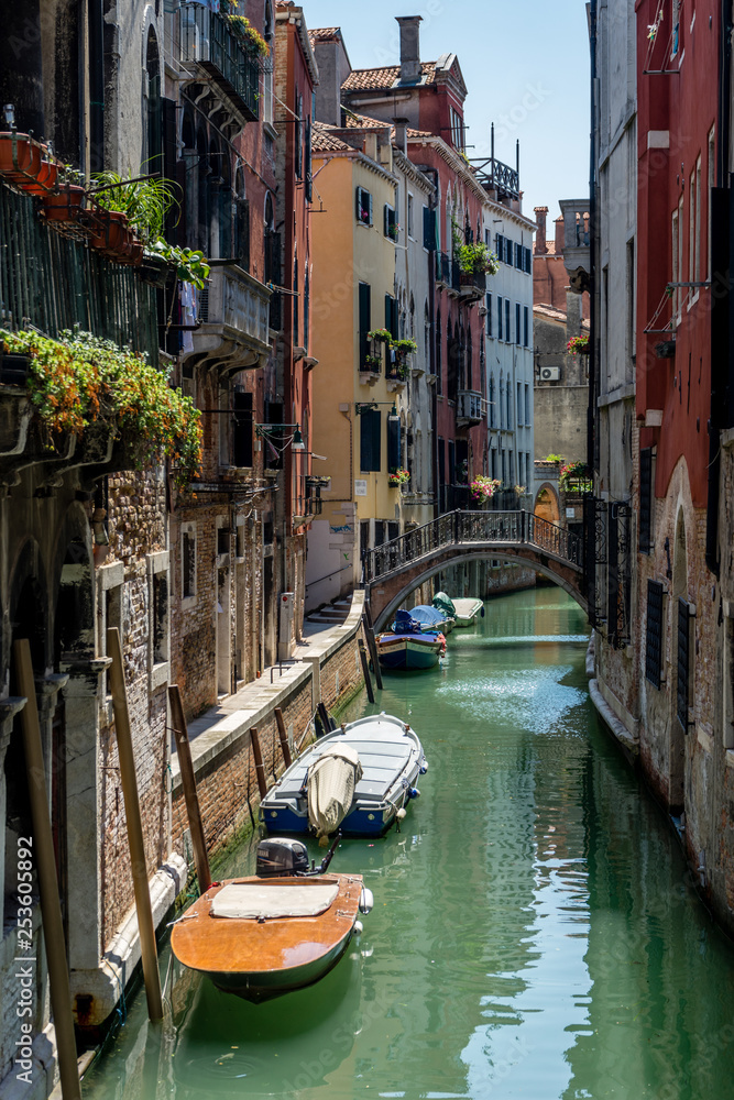 Italy, Venice, BOATS MOORED IN CANAL AMIDST BUILDINGS IN CITY