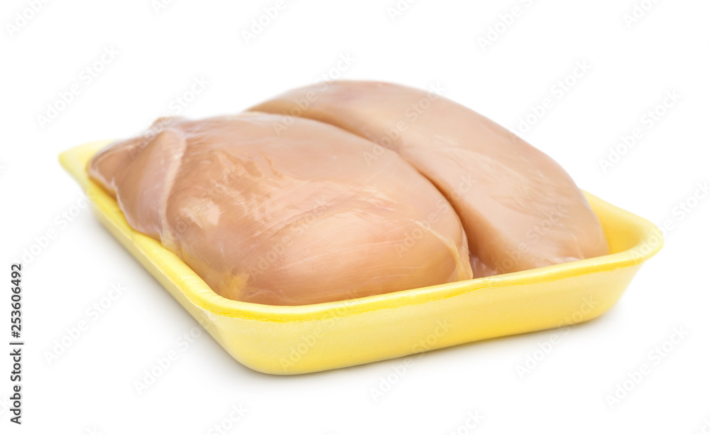 Raw chicken fillet in plastic tray on white. Raw chicken fillet in plastic tray on white.
