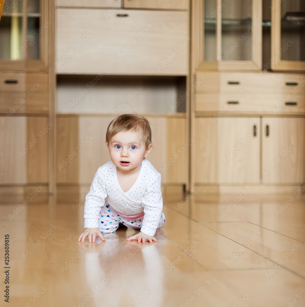 baby learning to crawl on floor in room. baby learning to crawl on floor in room.