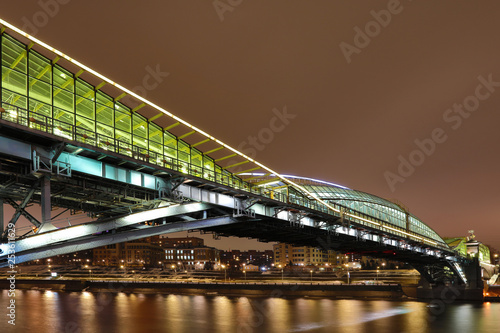 Moscow/Russia - March 6, 2019: Bogdan Khmelnitsky or Kievsky Pedestrian Bridge in Moscow in the March of 2019 year. The night view on Moskva river   photo