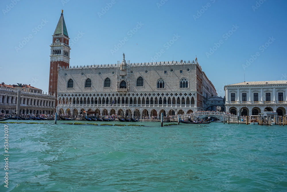 Italy, Venice, Doge's Palace, a castle like building with people in the water with Doge's Palace in the background