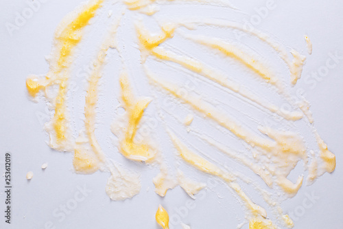 Smeared yellow jam on white.
