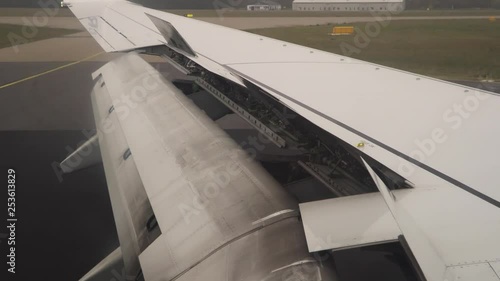 Aircraft wings inboard aileron lifting up for  maneuvering speed while landing at the airport