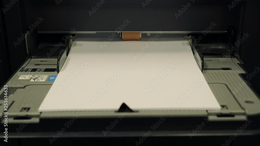 A4 paper being pulled into an industrial printer. A4 paper being pulled into an industrial printer.