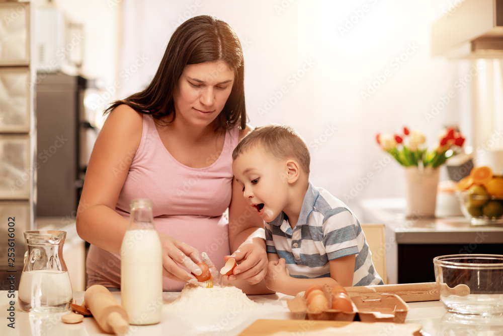 Mother and son in kitchen making cookies