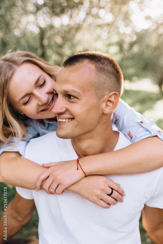 Portrait happy young smiling couple in love over flowering spring garden Portrait happy young smiling couple in love over flowering spring garden