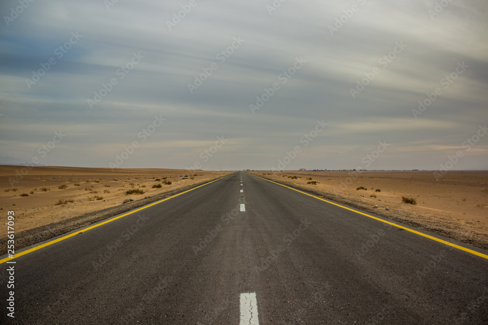 idyllic symmetry empty country side asphalt car road in Nevada in USA north America, picturesque scenery wallpaper pattern landscape in cloudy weather time 