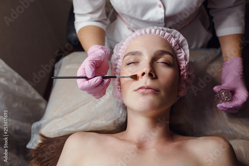 Beautician applies hyaluronic acid to the client's skin. photo