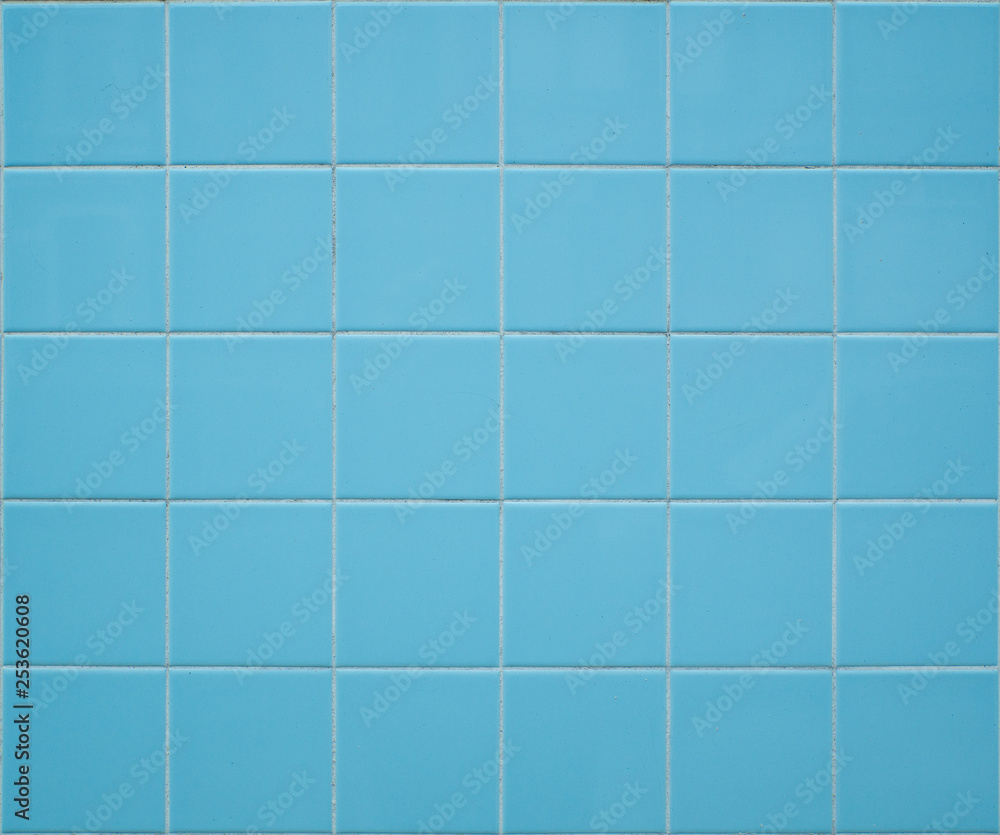 Light blue tiled wall background with square tiles