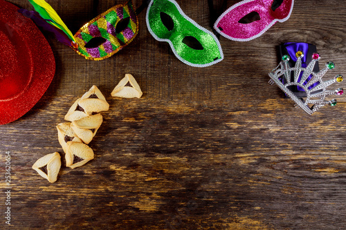 Hamantaschen cookies or hamans ears and mask for Purim celebration jewish carnival holiday selective focus