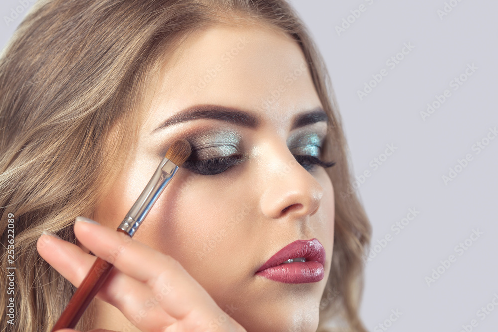 Makeup artist makes smoky eyes makeup. Applying make-up and face care. Makeup artist makes smoky eyes makeup. Applying make-up and face care.