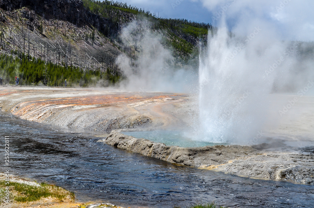 Geysers Erupt Near a River in Yellowstone National Park Geysers Erupt Near a River in Yellowstone National Park